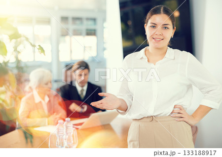Young woman in business clothes posing in office Young woman in business clothes posing in office 133188917