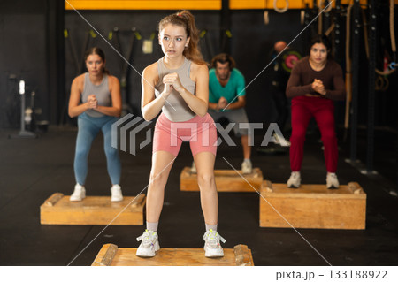 Young woman stepping on box at Crossfit workout 133188922