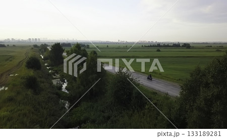 Aerial view of motorcyclist riding on a rural road. Clip Aerial view of motorcyclist riding on a rural road. Clip 133189281