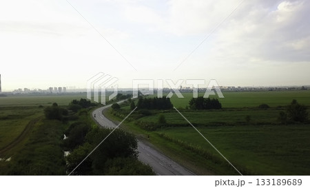 Aerial view of motorcycle riding on country road. Clip Aerial view of motorcycle riding on country road. Clip 133189689