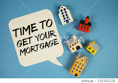 Time To Get Your Mortgage text with house models on blue background Time To Get Your Mortgage text with house models on blue background 133191218