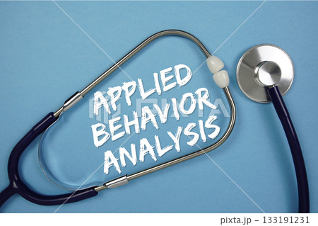 Applied Behavior Analysis text with stethoscope on blue background 133191231