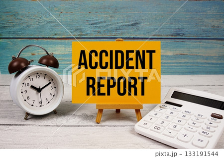 Accident Report text written on paper card with calculator and alarm clock on wooden background Accident Report text written on paper card with calculator and alarm clock on wooden background 133191544