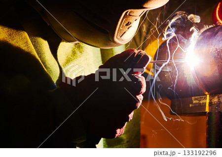 Close-up image of industrial worker at the factory welding. Close-up image of industrial worker at the factory welding. 133192296