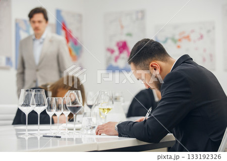 Sommelier examination to get certificate professional work of winemaking. Blind wine tasting. Sommelier degustate wine. 133192326