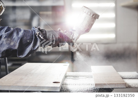 Staining wood with white spray gun. Application of flame retardant ensuring fire protection, airless spraying device. Staining wood with white spray gun. Application of flame retardant ensuring fire protection, airless spraying device. 133192350