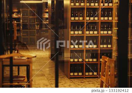 Wine room with many various alcoholic beverage. Cellar for storing alcohol at an ideal temperature.  133192412