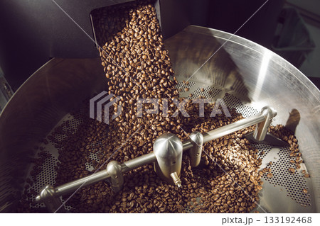 Freshly Roasted Coffee Beans Unloading Into Rotating Cooling Drum Freshly Roasted Coffee Beans Unloading Into Rotating Cooling Drum 133192468