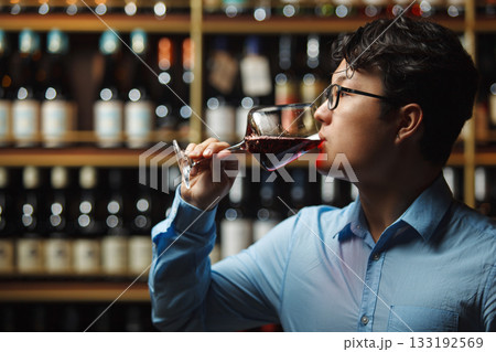 Skilled Wine Expert Tasting Vintage Red in Cellar, Close Up Skilled Wine Expert Tasting Vintage Red in Cellar, Close Up 133192569