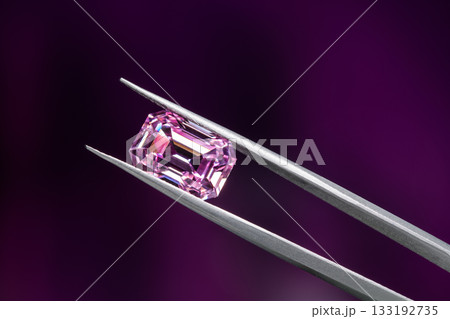 A pink diamond is displayed in a jeweler's setting A pink diamond is displayed in a jeweler's setting 133192735