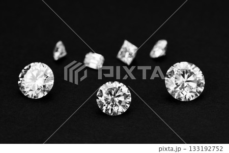 Three white diamonds are displayed on a black background 133192752