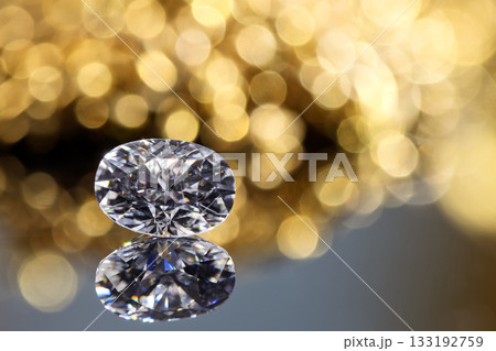 A diamond is sitting on a table with a blurry background 133192759