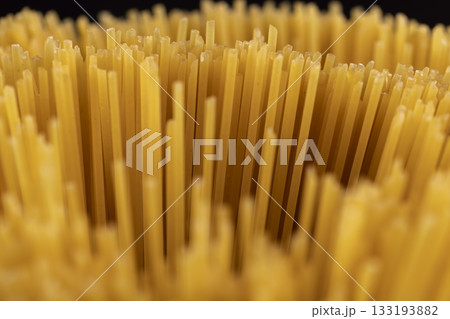 thin, long, hard yellow spaghetti made from durum flour using water , not cooked , hard spaghetti made from high-quality wheat flour 133193882