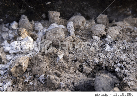 burnt coals from logs with a lot of dust and fumes, dust and burnt coals after cooking meat in the grill 133193896