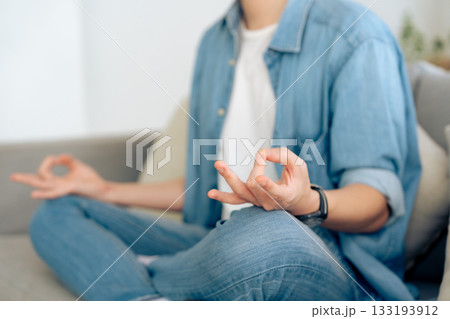 Happy young Asian man practicing yoga and meditation at home Happy young Asian man practicing yoga and meditation at home 133193912