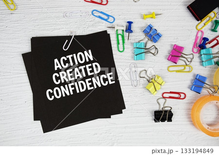 Action Created Confidence text on stick note with stationery on concrete background 133194849