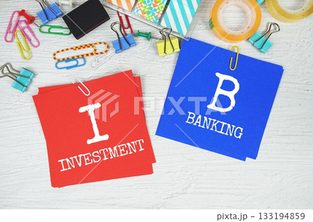 IB - Investment Banking text on stick note with stationery on concrete background 133194859