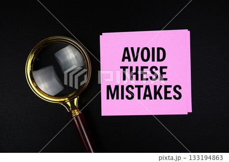 Avoid These Mistakes text on sticky note with magnifying glass on black background Avoid These Mistakes text on sticky note with magnifying glass on black background 133194863
