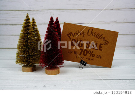 Festive display with small decorative Christmas trees with "Special Offer Merry Christmas Big Sale up to 70% off, Promotion Holiday Sale Event 133194918