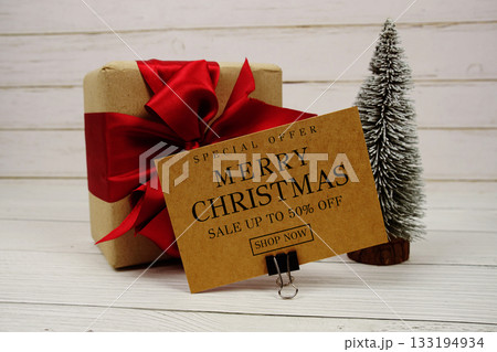 Festive display with small decorative Christmas trees and gift box present with "Special Offer Merry Christmas Big Sale up to 50% off, Promotion Holiday Sale Event Festive display with small decorative Christmas trees and gift box present with "Special Offer Merry Christmas Big Sale up to 50% off, Promotion Holiday Sale Event 133194934