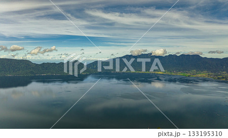 Blue lake Maninjau in a crater among the mountains. Sumatra, Indonesia. Blue lake Maninjau in a crater among the mountains. Sumatra, Indonesia. 133195310