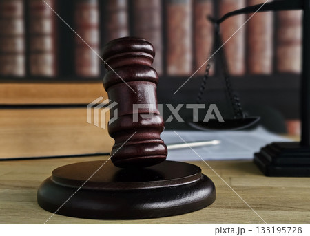 Justice is served with a gavel and scales of justice in a courtroom Justice is served with a gavel and scales of justice in a courtroom 133195728