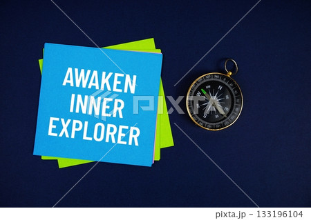 Awaken Inner Explorer text written on sticky note with compass on blue background Awaken Inner Explorer text written on sticky note with compass on blue background 133196104