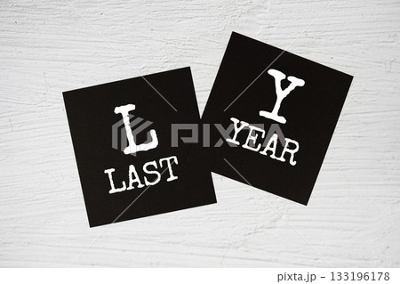 LY - Last Year text on stick note on concrete background LY - Last Year text on stick note on concrete background 133196178