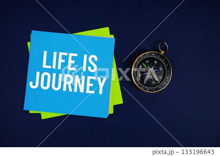 Life Is Journey text written on sticky note with compass on blue  background 133196643