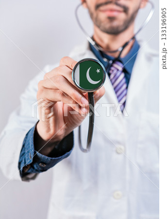 Pakistan health and medical insurance concept. Pakistan healthcare system, doctor holding stethoscope Pakistan health and medical insurance concept. Pakistan healthcare system, doctor holding stethoscope 133196905