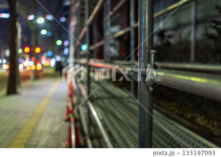 Nighttime Urban street scene with scaffolding and traffic lights Nighttime Urban street scene with scaffolding and traffic lights 133197093