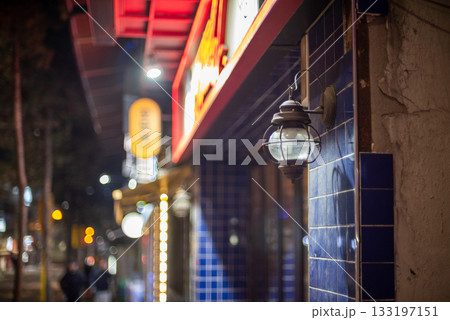 Street scene with blue-tiled wall and vintage lamp at night in Seoul, South Korea 133197151
