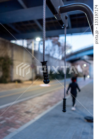 Outdoor exercise equipment with handles under a bridge in Hangang Han river park in Seoul, South Korea 133197174