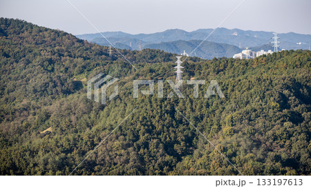 Scenic hills with power lines and distant mountains Scenic hills with power lines and distant mountains 133197613