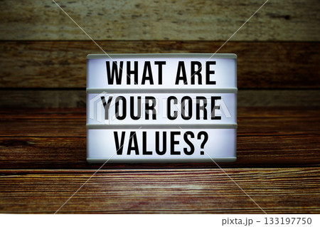 Lightbox with text "What Are Your Core Values?" on wooden background 133197750