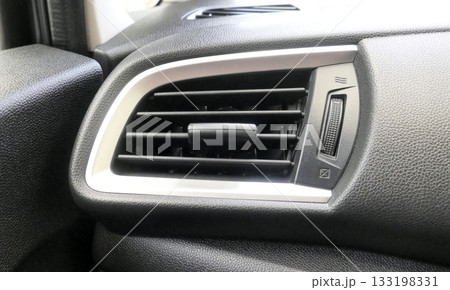 Air vents in the front of the car next to the driver 133198331