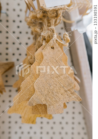 Rustic wooden christmas tree ornaments on display at market Rustic wooden christmas tree ornaments on display at market 133198591