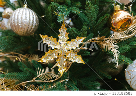 Festive christmas tree with golden ornaments and glittering decorations 133198593