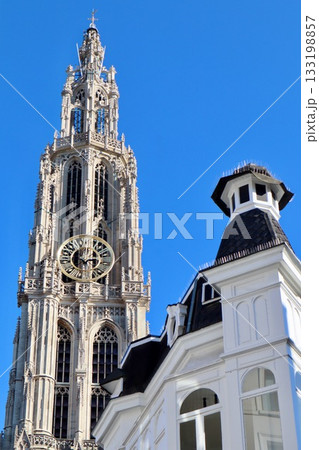 Cathedral of Our Lady tower and architectural details against a clear blue sky in Antwerp, Belgium Cathedral of Our Lady tower and architectural details against a clear blue sky in Antwerp, Belgium 133198857