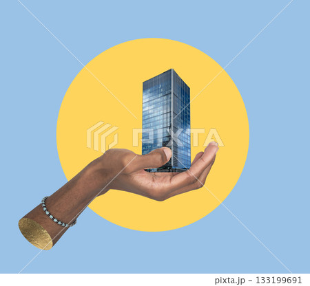 Hand holding skyscraper model. Symbol of urban development, architecture, and modern city growth, 133199691