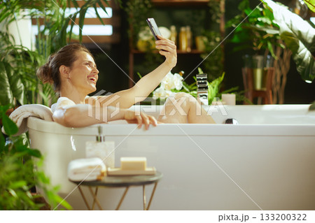 Joyful Selfie Moment in a Lush Bubble Bath 133200322