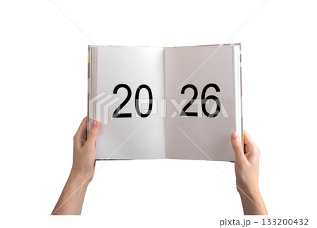 Hands holding open planner with bold numbers 2026 on white pages, concept of future planning, goals, Hands holding open planner with bold numbers 2026 on white pages, concept of future planning, goals, 133200432