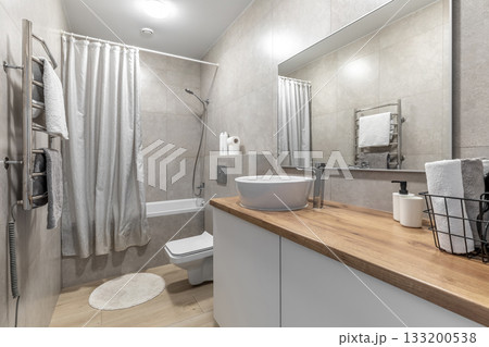 Modern Bathroom with Wooden Countertop and Electric Towel Dryer Modern Bathroom with Wooden Countertop and Electric Towel Dryer 133200538