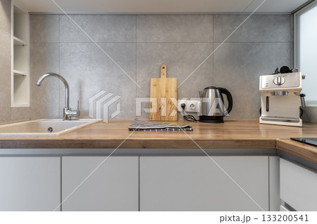 Modern Kitchen Countertop with Sink and Coffee Machine Modern Kitchen Countertop with Sink and Coffee Machine 133200541