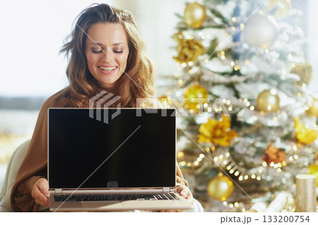 Joyful Woman Reflecting While Using Laptop Joyful Woman Reflecting While Using Laptop 133200754