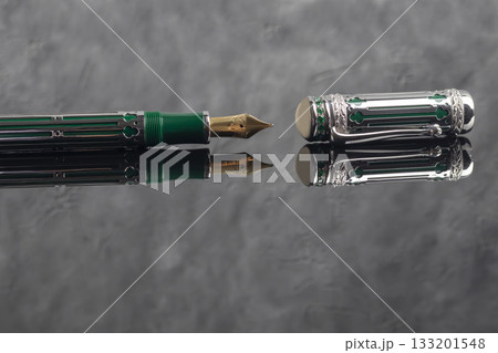 Fountain pen on a gray marble background. Boxed and unboxed. Selective focus. 133201548