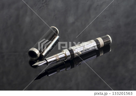 Fountain pen on a gray marble background. Boxed and unboxed. Selective focus. 133201563