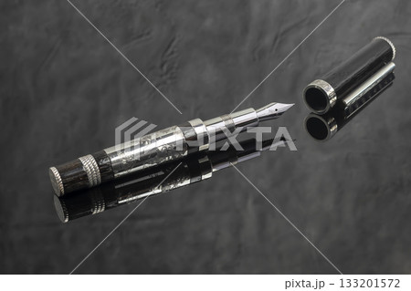Fountain pen on a gray marble background. Boxed and unboxed. Selective focus. 133201572