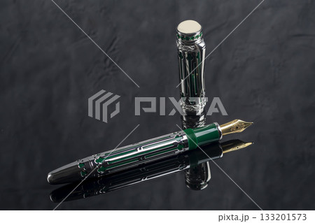 Fountain pen on a gray marble background. Boxed and unboxed. Selective focus. 133201573