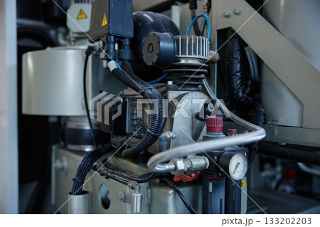A detailed close up of a compressor machine featuring two gauges situated on it A detailed close up of a compressor machine featuring two gauges situated on it 133202203